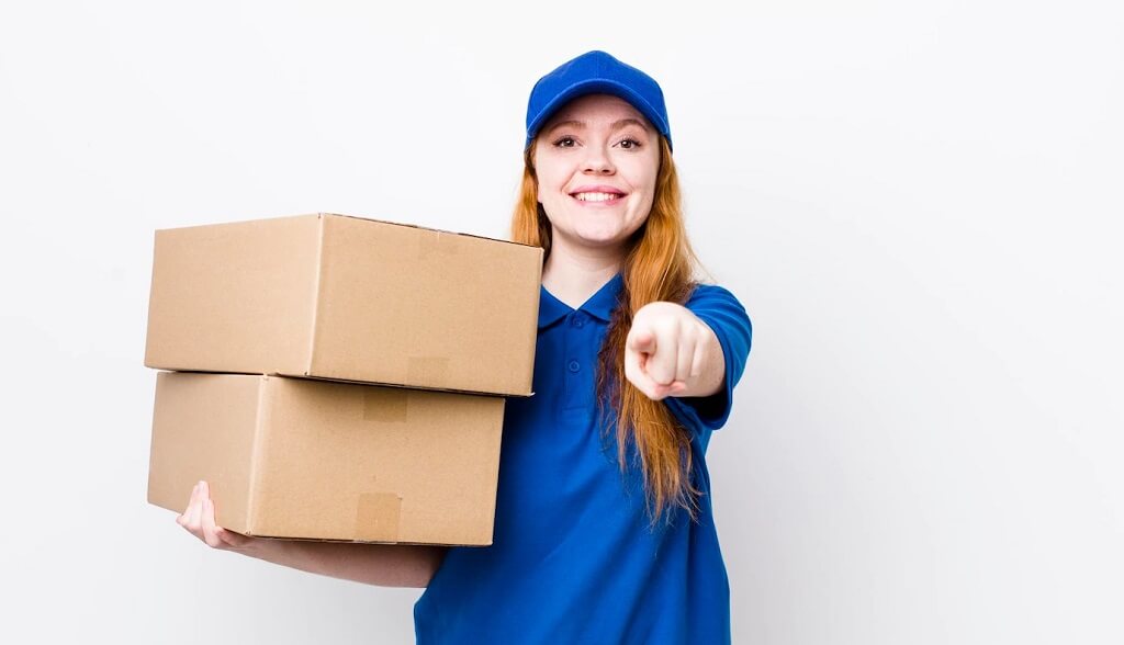 Smiling courier holding two cardboard boxes