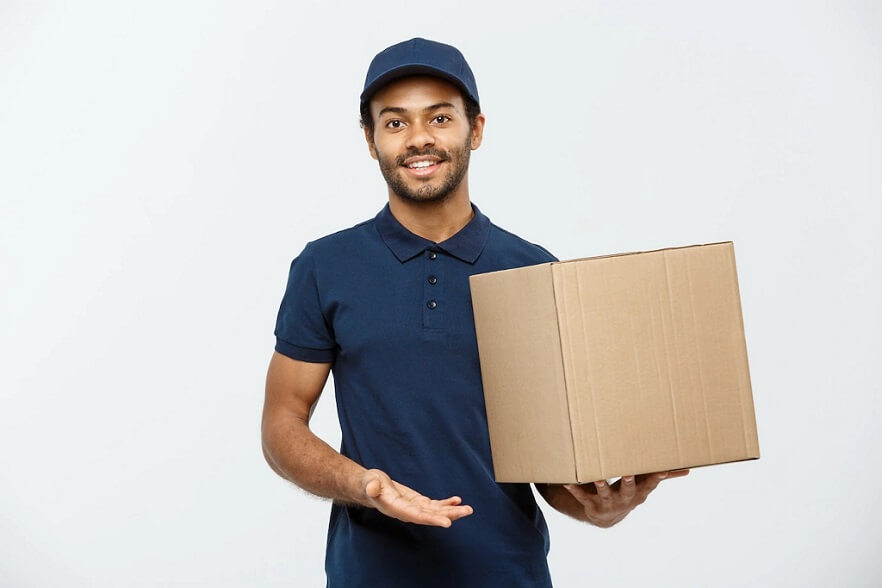 Smiling male courier presenting a cardboard box